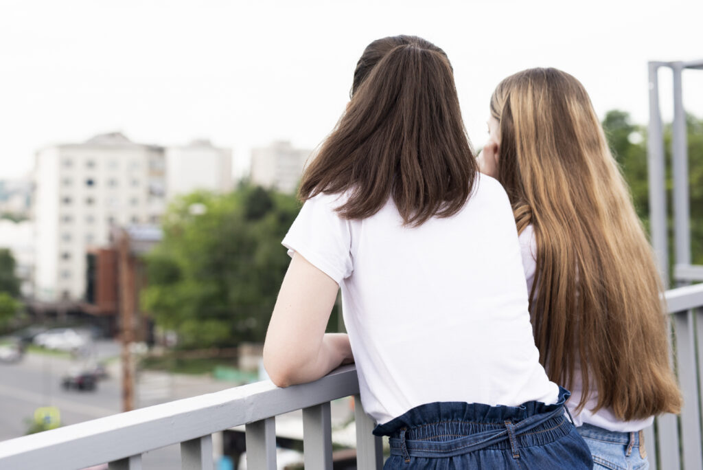 back-view-best-friends-balcony