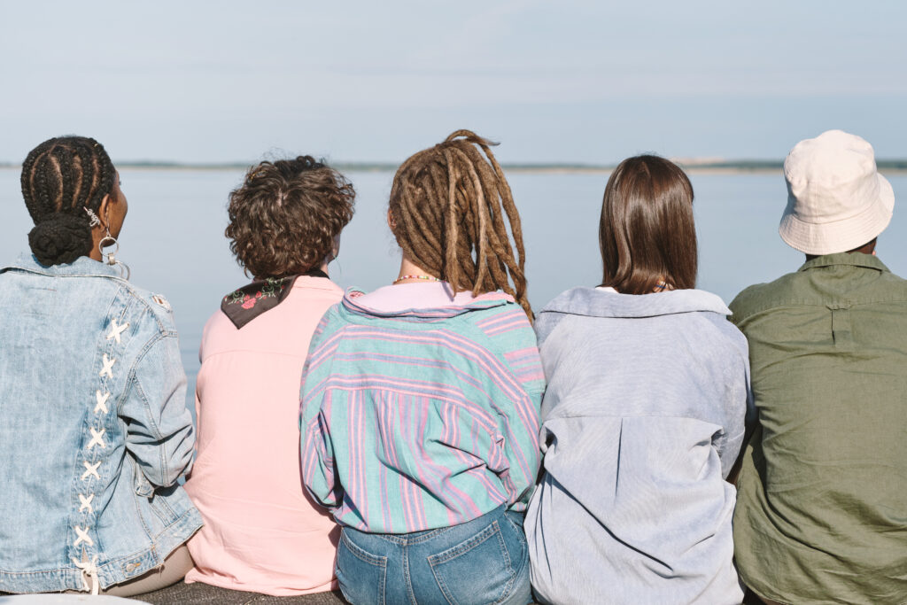 Rear view of young intercultural friends in casualwear sijaishuolto lapsille Pirkanmaa